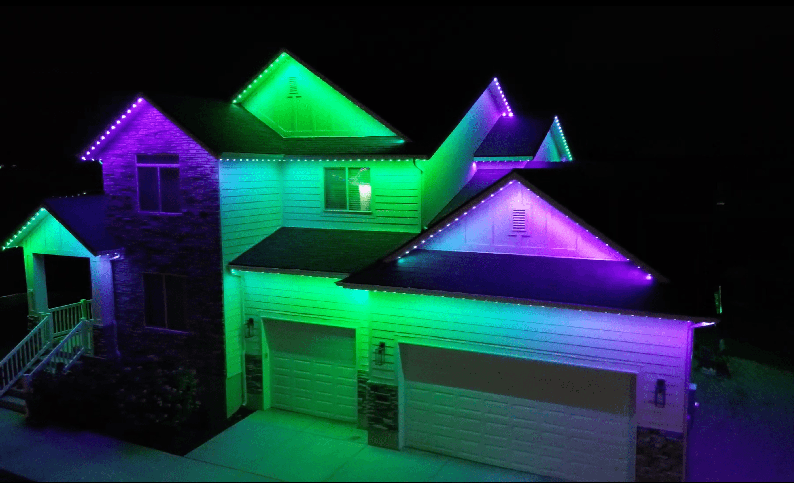 Permanent holiday lighting displaying orange and purple for Halloween on a home (TruLight network install)